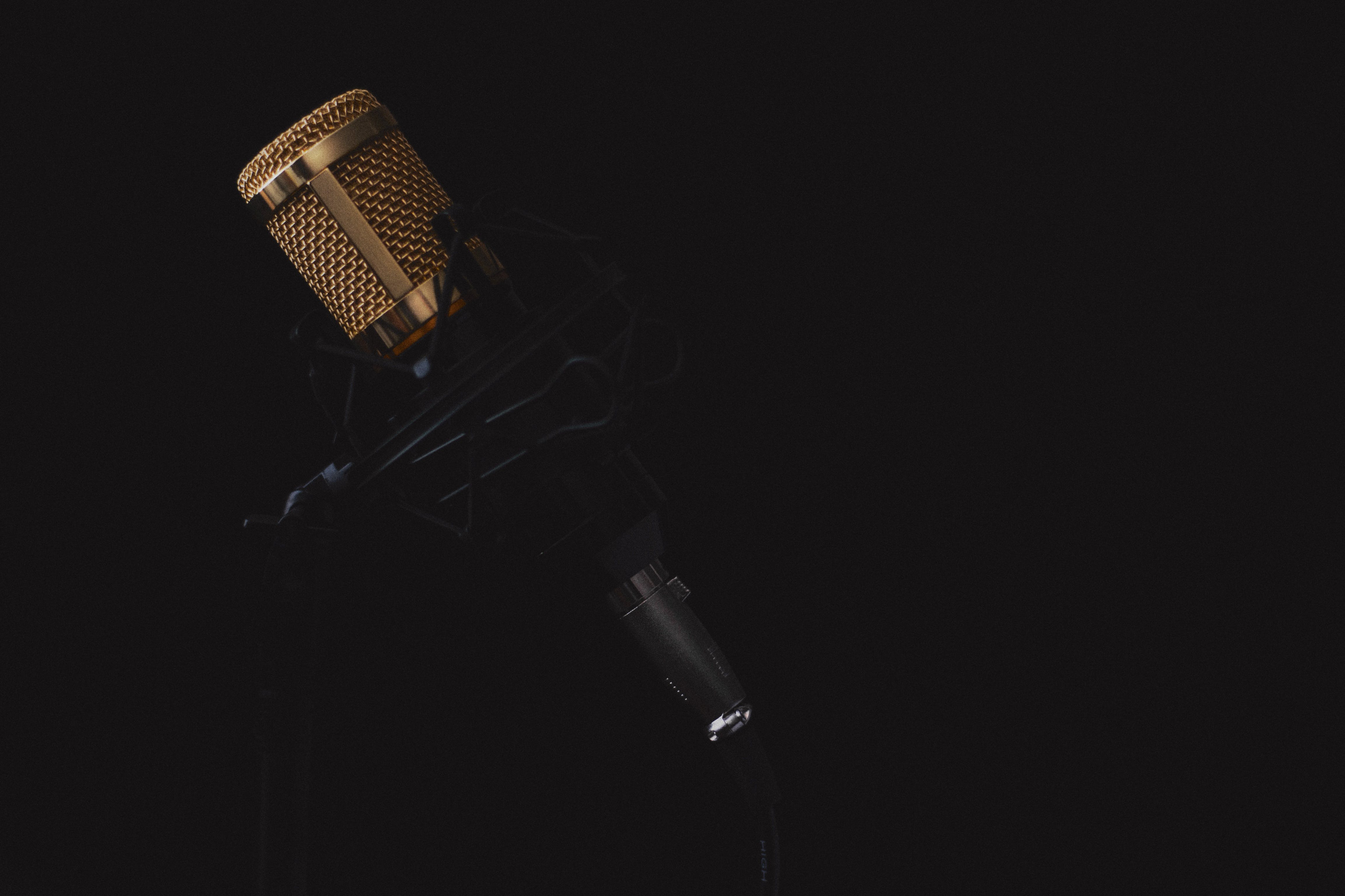 gold-plated microphone on dark background